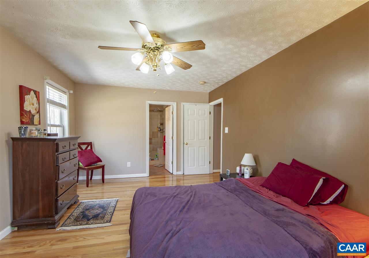 203 Quail Run Amherst, VA 24521 - Photo 20 of 45 a bedroom with a bed and wooden floor