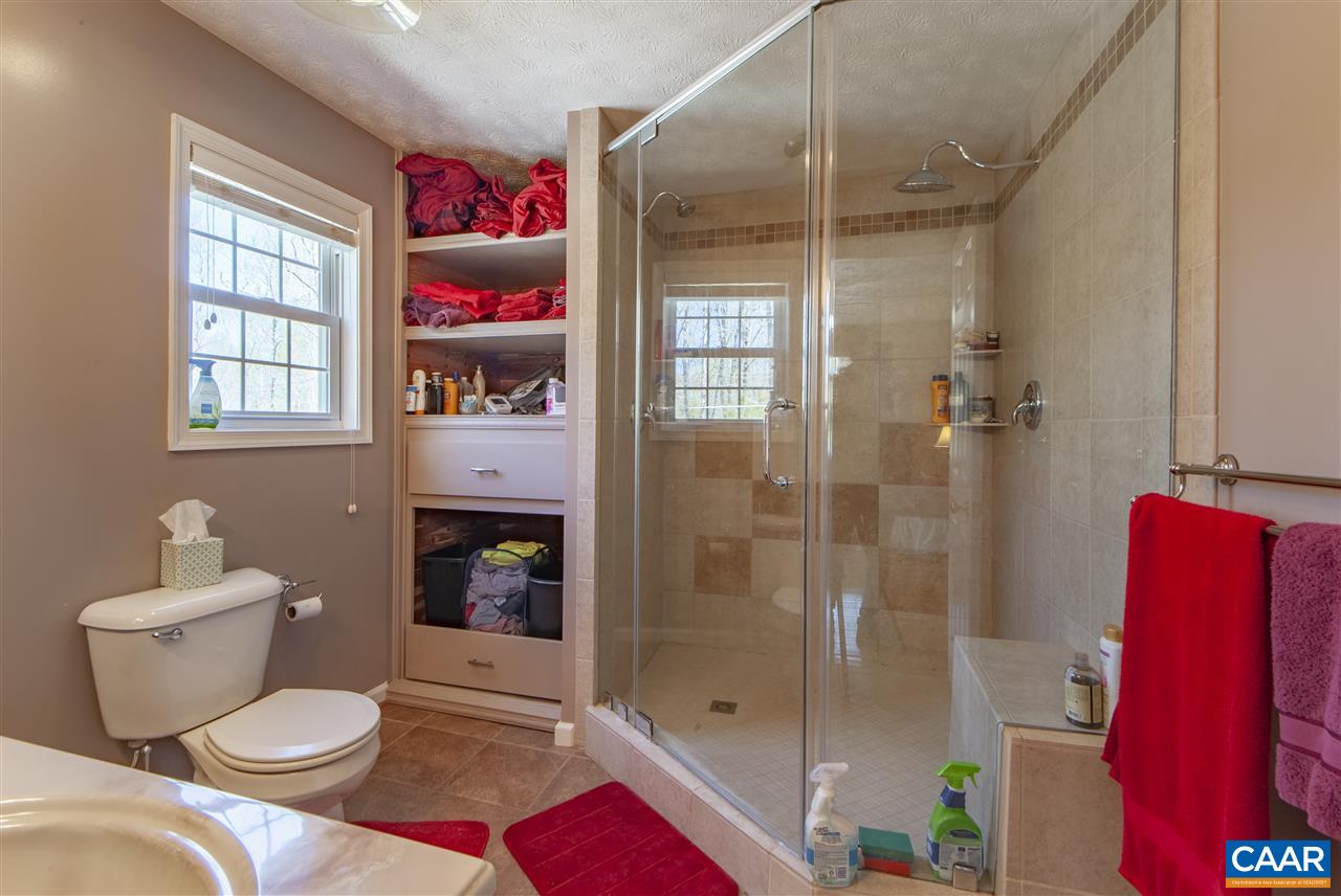 203 Quail Run Amherst, VA 24521 - Photo 21 of 45 a bathroom with a shower sink and mirror