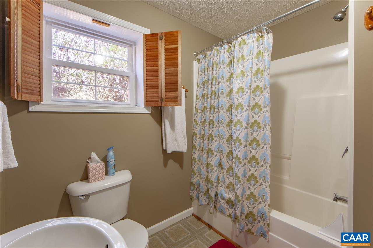 203 Quail Run Amherst, VA 24521 - Photo 35 of 45 a bathroom with a toilet and shower curtain