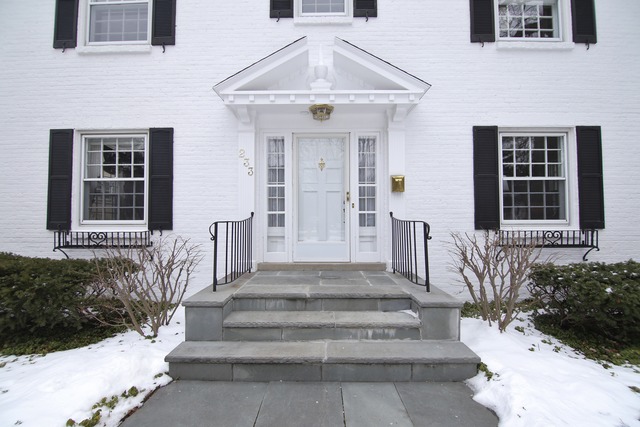 233 Ridge Avenue Winnetka, IL 60093 - Photo 2 of 25 a front view of a house with a garden