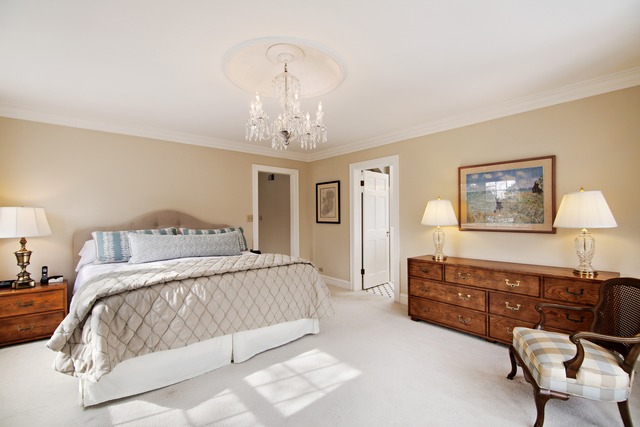 233 Ridge Avenue Winnetka, IL 60093 - Photo 11 of 25 a bedroom with a large bed and a chandelier
