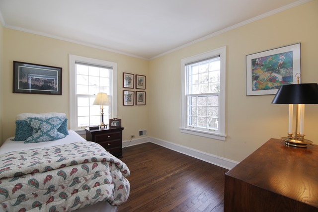 233 Ridge Avenue Winnetka, IL 60093 - Photo 16 of 25 a bedroom with a bed and wooden floor