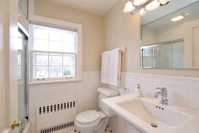 233 Ridge Avenue Winnetka, IL 60093 - Photo 17 of 25 a bathroom with a sink a toilet and a mirror