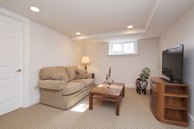 233 Ridge Avenue Winnetka, IL 60093 - Photo 22 of 25 a living room with furniture and a flat screen tv