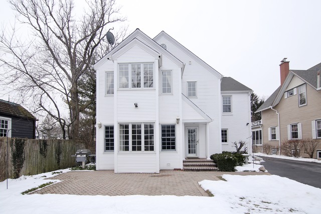 233 Ridge Avenue Winnetka, IL 60093 - Photo 23 of 25 a front view of a house with a yard