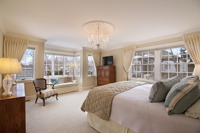 233 Ridge Avenue Winnetka, IL 60093 - Photo 10 of 25 a spacious bedroom with a bed and a large window