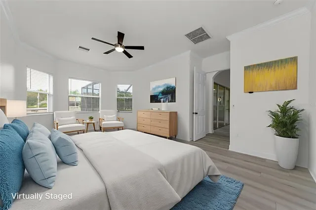 a view of empty room with wooden floor and ceiling fan
