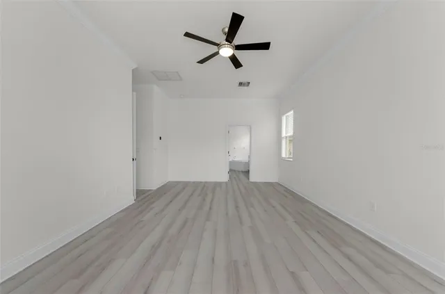 a bathroom with a tub shower and hallway