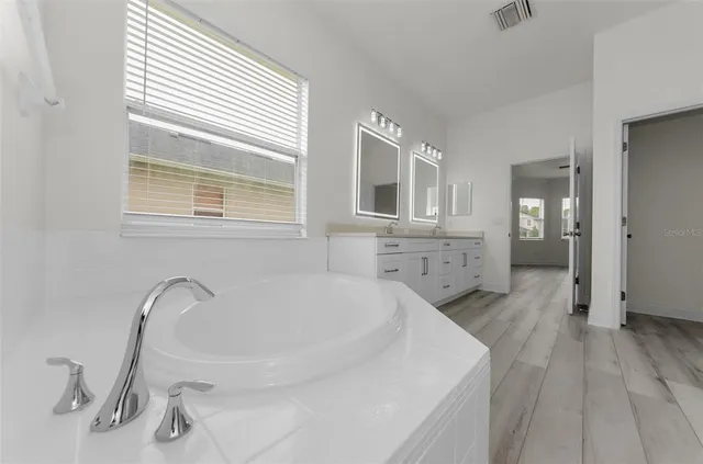 a bathroom with a sink a mirror and a toilet