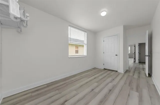 a utility room with closet and window