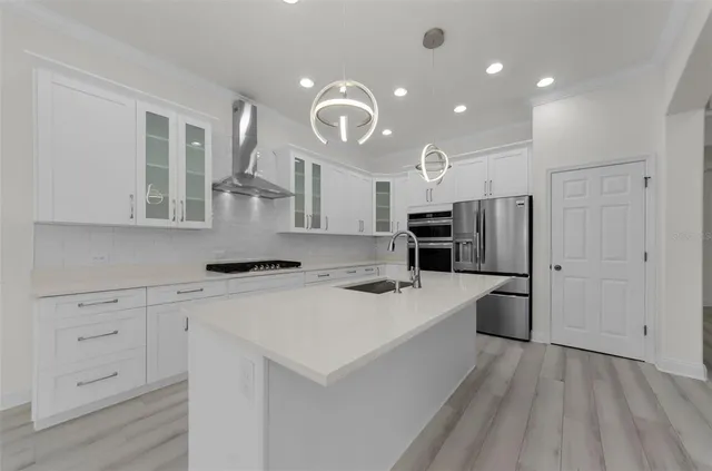 a kitchen with a sink a stove and cabinets