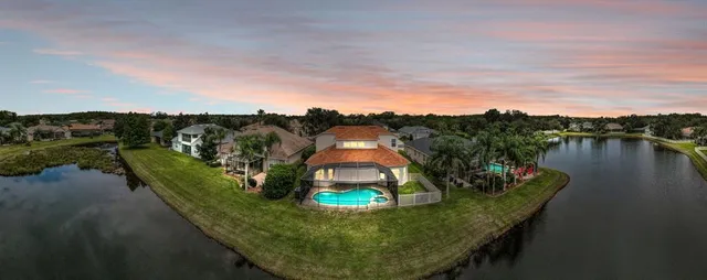 a view of a house with a yard and potted plants