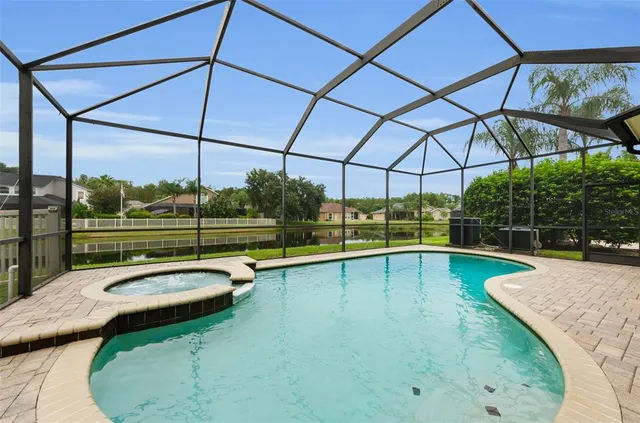 a view of a backyard with swimming pool