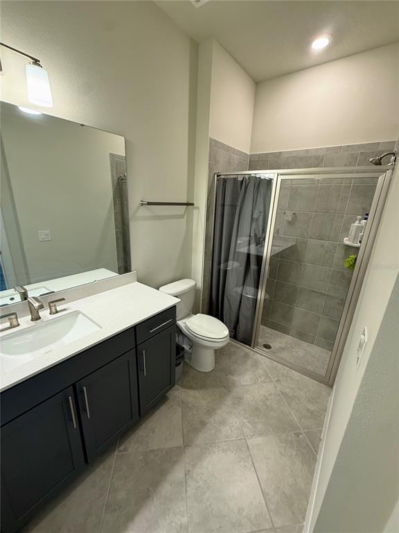 8441 Pk Clf Way Orlando, FL 32836 - Photo 49 of 59 a bathroom with a double vanity sink toilet and shower