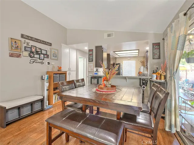 a view of a dining room with furniture and a window