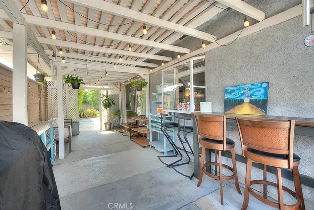 a dining room with furniture and a large window