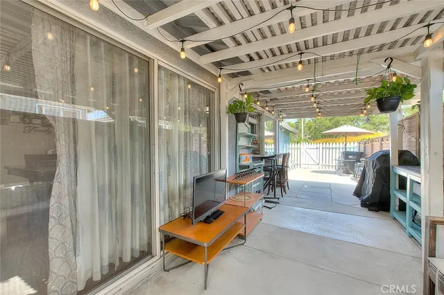 a building outdoor space with patio furniture and potted plants