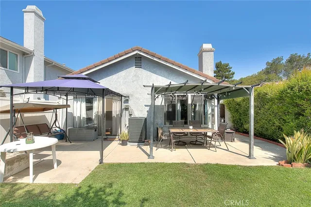 a view of a patio with a table and chairs and potted plants
