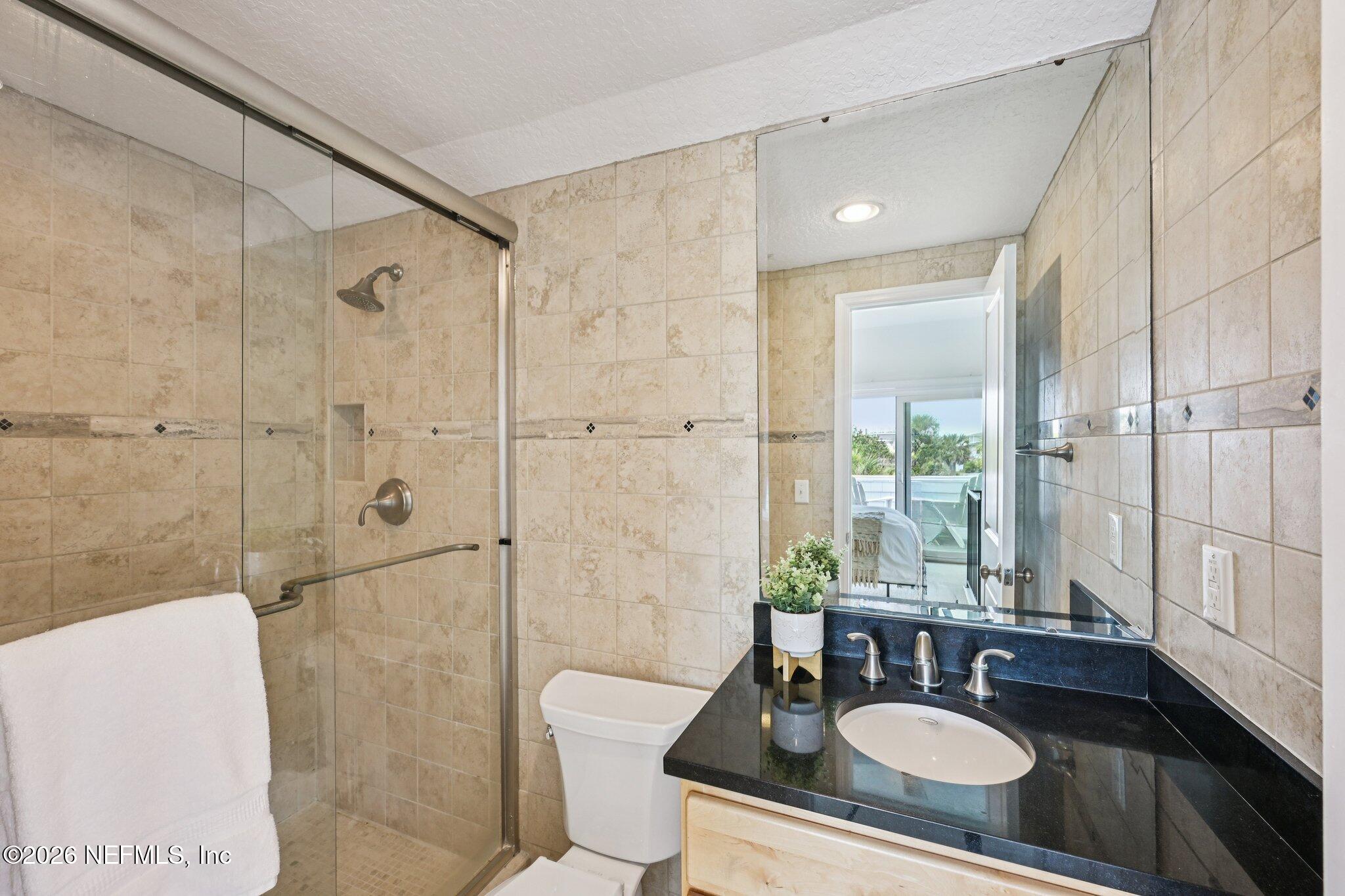 2802 2nd Street South Jacksonville Beach, FL 32250 - Photo 39 of 53 a bathroom with a sink double vanity shower and a mirror