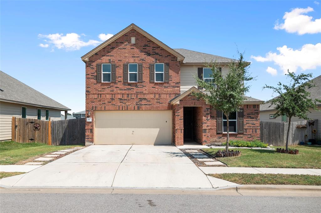 a front view of a house with a yard and garage