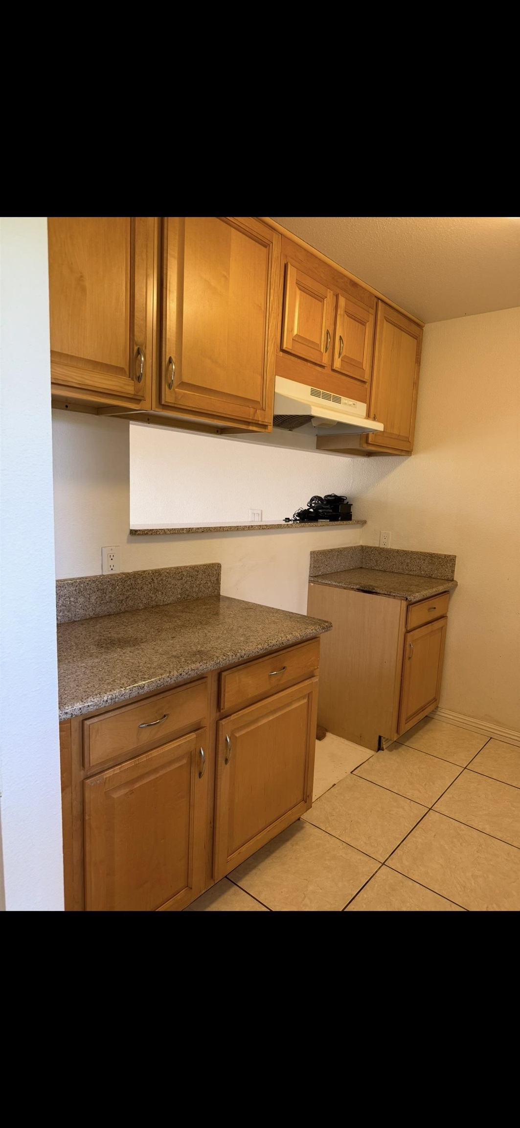 140 Uwapo Road, Unit 35204 Kihei, HI 96753 - Photo 12 of 16 a view of a kitchen with wooden floor and a black white refrigerator