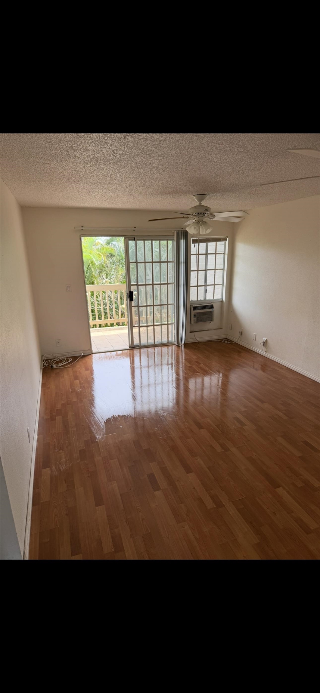 140 Uwapo Road, Unit 35204 Kihei, HI 96753 - Photo 15 of 16 a view of an empty room with wooden floor
