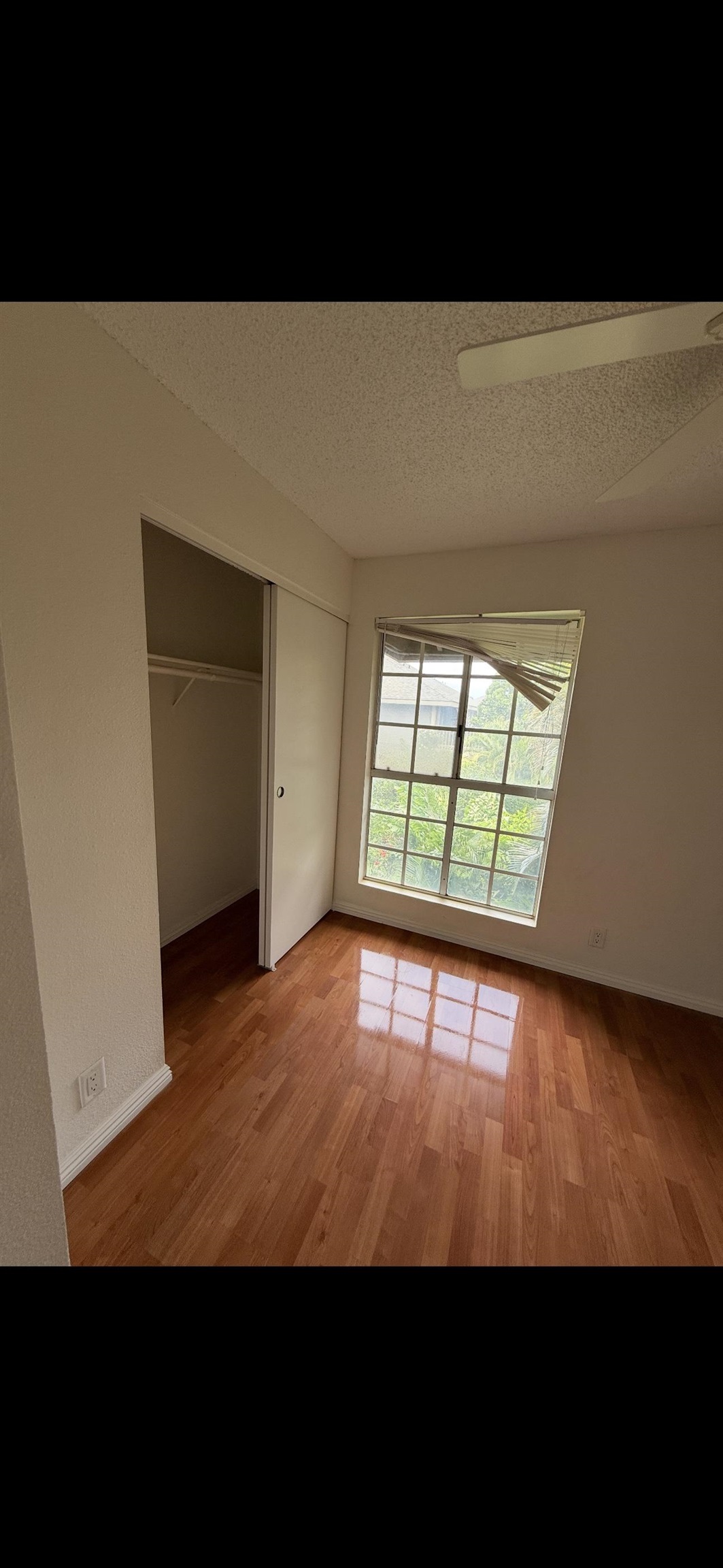 140 Uwapo Road, Unit 35204 Kihei, HI 96753 - Photo 7 of 16 a view of empty room with wooden floor and fan