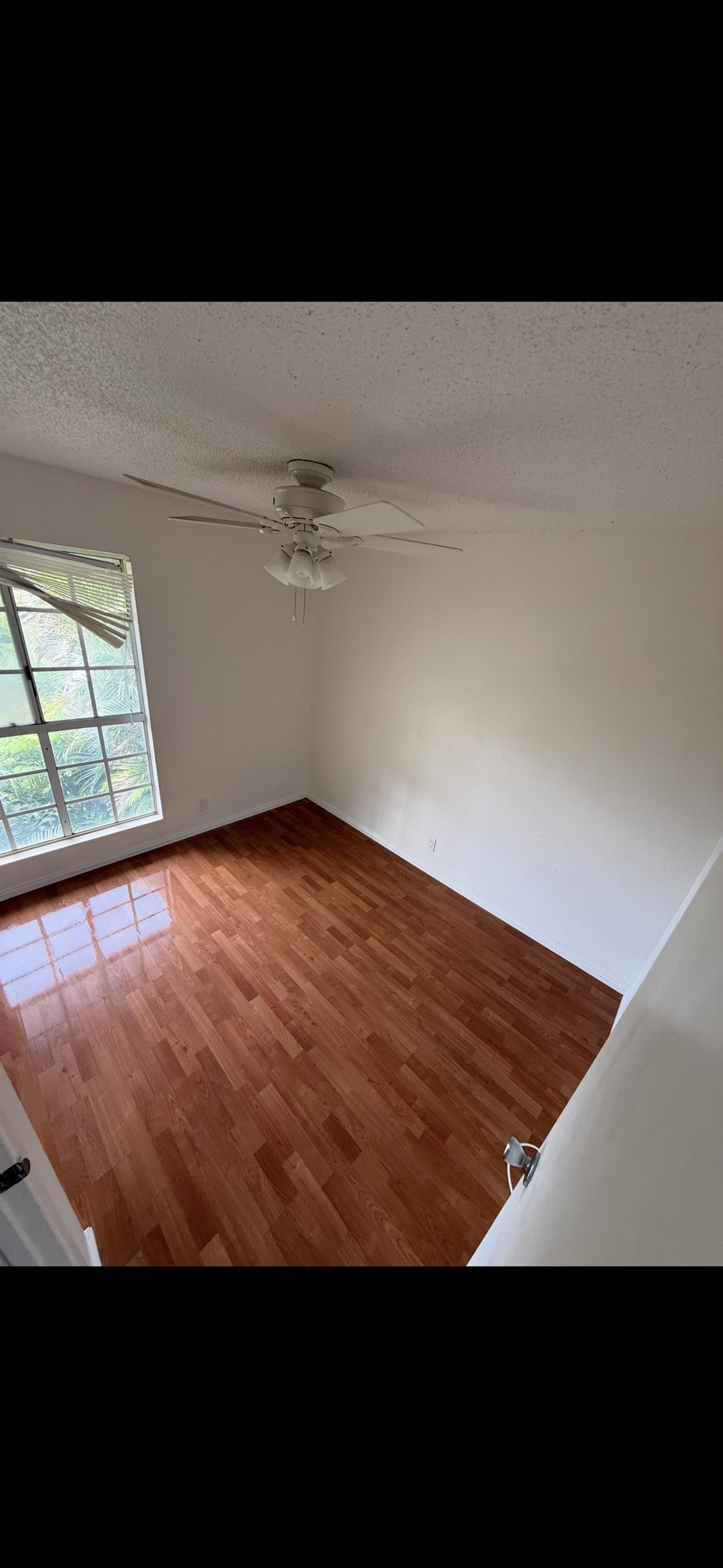 140 Uwapo Road, Unit 35204 Kihei, HI 96753 - Photo 8 of 16 a view of an empty room with wooden floor and a window