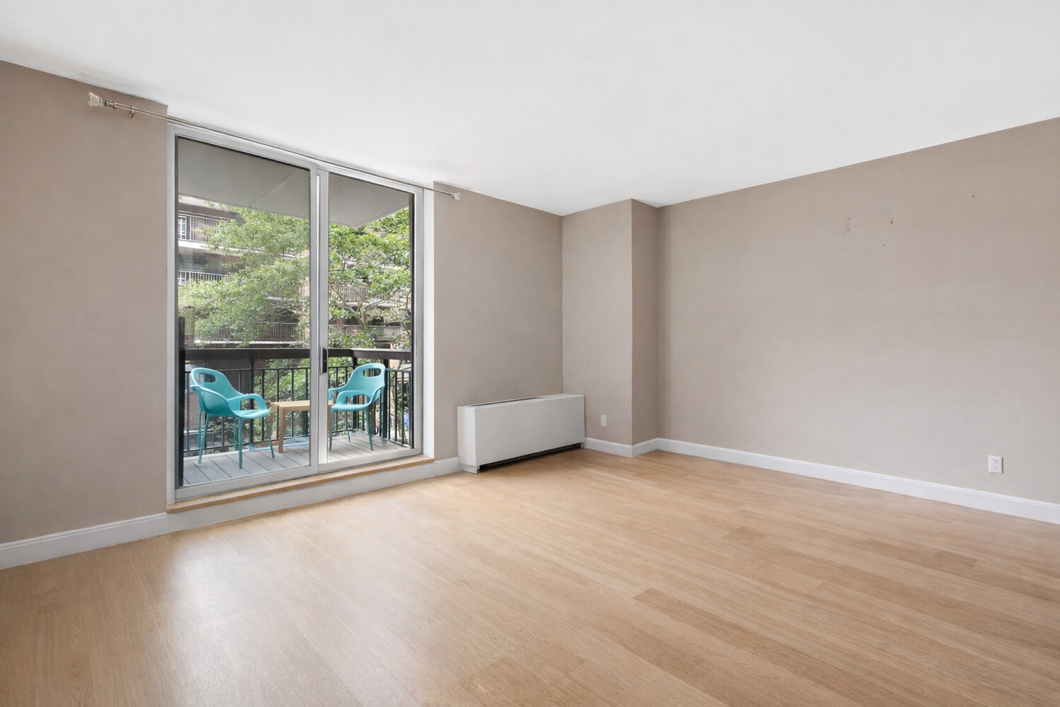 333 Rector Place, Unit 301 Manhattan, NY 10280 - Photo 2 of 7 a view of an empty room with wooden floor and a window