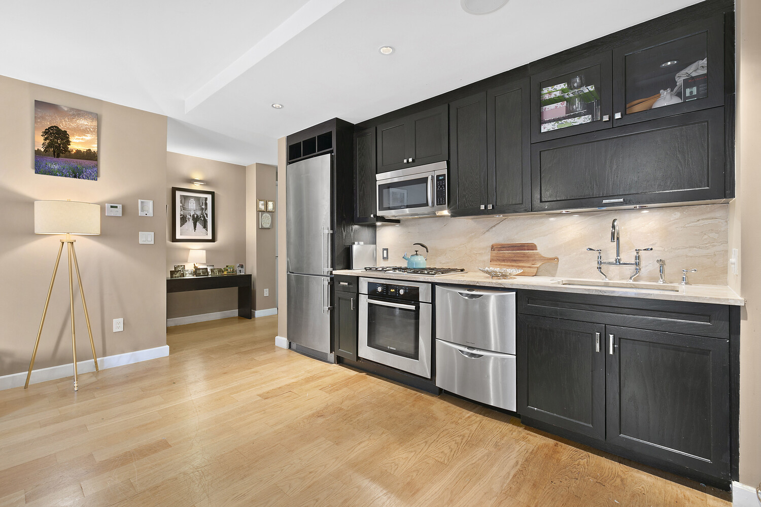 333 Rector Place, Unit 301 Manhattan, NY 10280 - Photo 3 of 7 a kitchen with stainless steel appliances granite countertop a refrigerator and a stove top oven