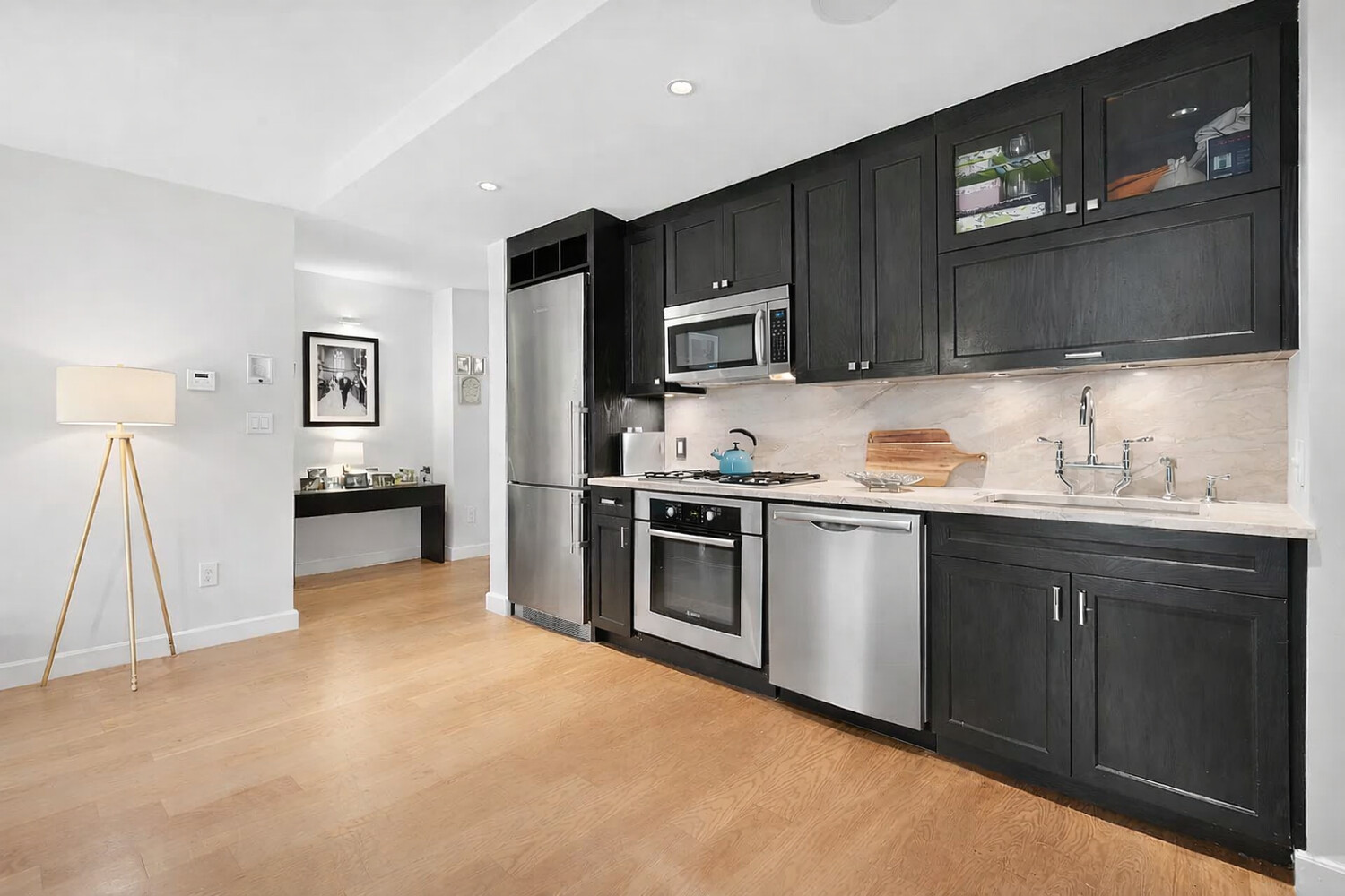 333 Rector Place, Unit 301 Manhattan, NY 10280 - Photo 5 of 8 a kitchen with granite countertop a refrigerator and a stove top oven