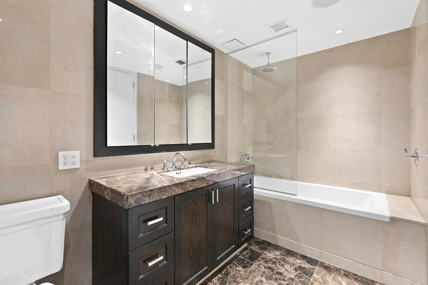 333 Rector Place, Unit 301 Manhattan, NY 10280 - Photo 6 of 7 a bathroom with a granite countertop sink a toilet and a bathtub