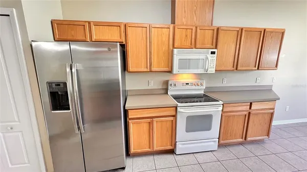 a kitchen with a stove a sink and a refrigerator