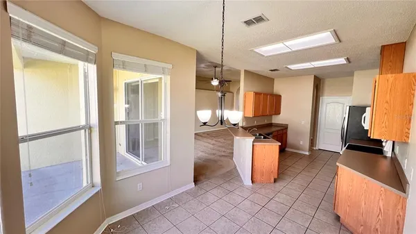 a kitchen with a refrigerator and a counter top space