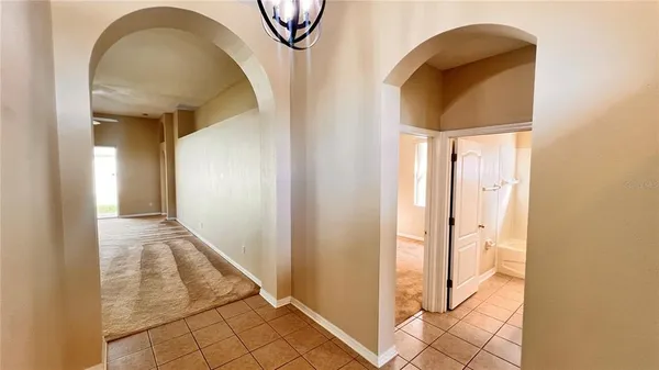 a view of a hallway with wooden floor and dining room