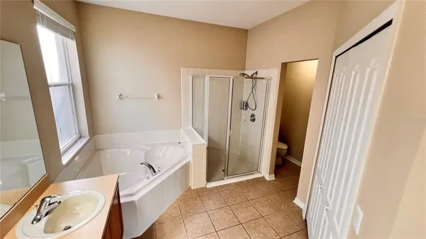 a bathroom with a tub a sink and a shower