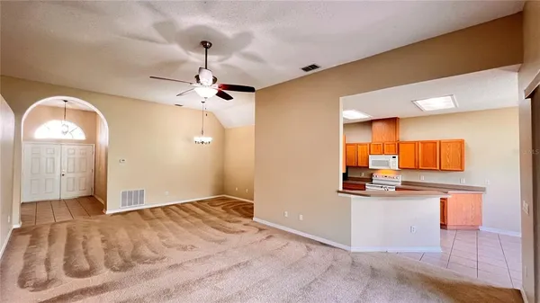 a view of kitchen with stainless steel appliances granite countertop cabinets and window