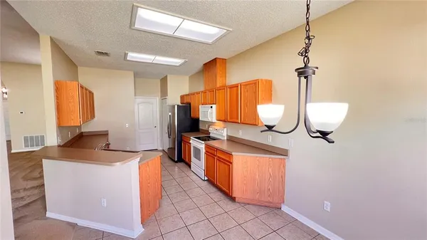 a kitchen with stainless steel appliances granite countertop a sink and a stove