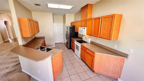 a kitchen with stainless steel appliances a refrigerator and a stove