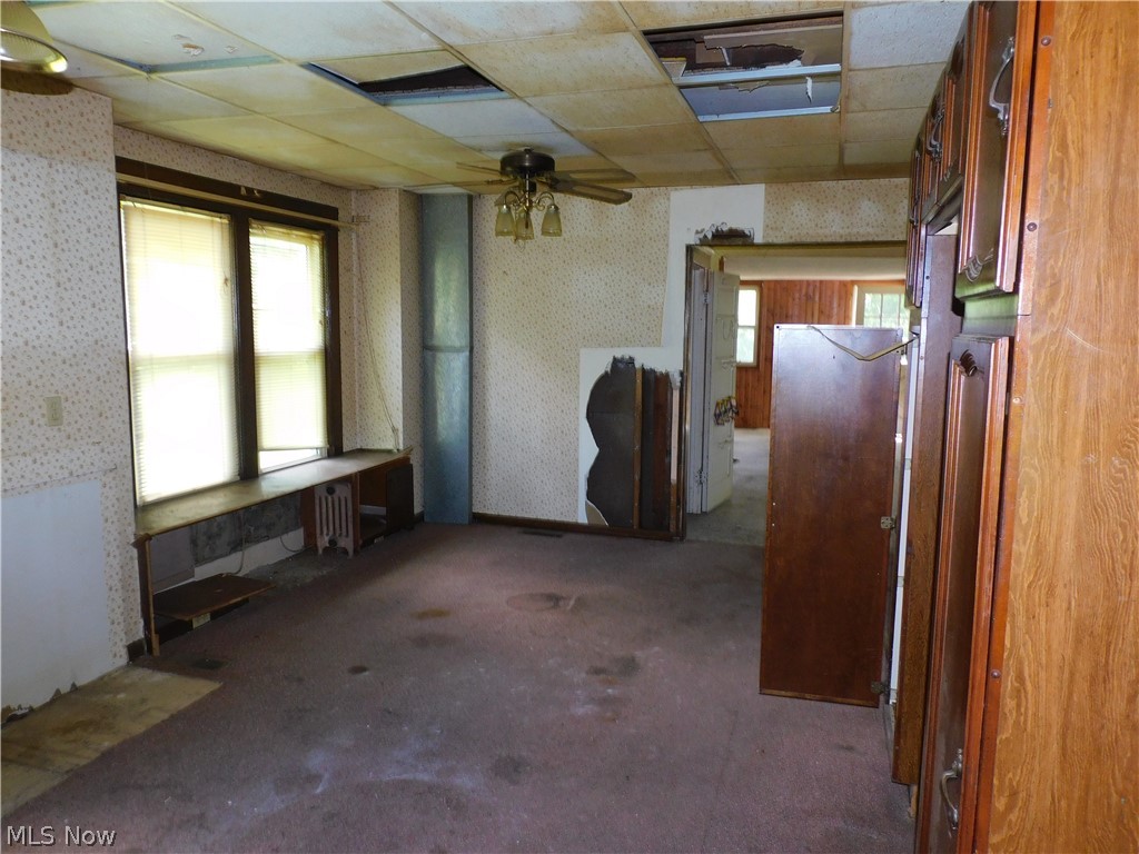 4031 South Ridge Road East Ashtabula, OH 44004 - Photo 10 of 25 Spare room featuring carpet floors, ceiling fan, and a paneled ceiling