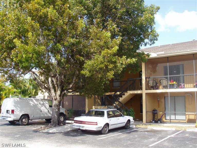 5329 Summerlin Road, Unit 2913 Fort Myers, FL 33919 - Photo 1 of 12 a car parked in front of a white house