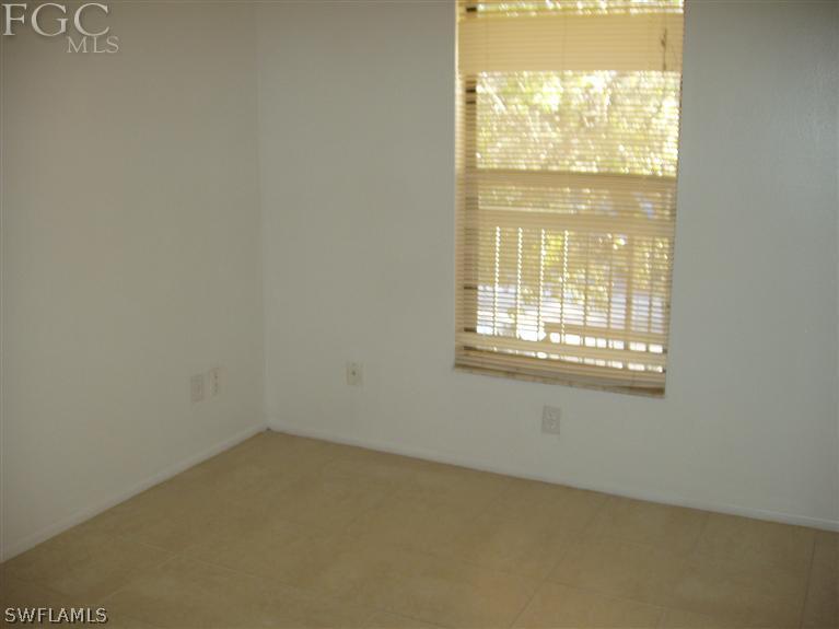 5329 Summerlin Road, Unit 2913 Fort Myers, FL 33919 - Photo 8 of 12 a view of an empty room with a window