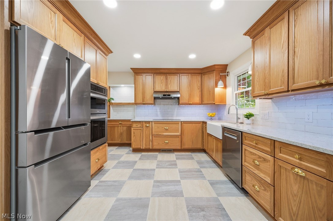 1515 Barlow Road Hudson, OH 44236 - Photo 6 of 31 Completely renovated kitchen with custom cabinetry, induction cooktop, stainless steel appliances, and porcelain tile flooring!