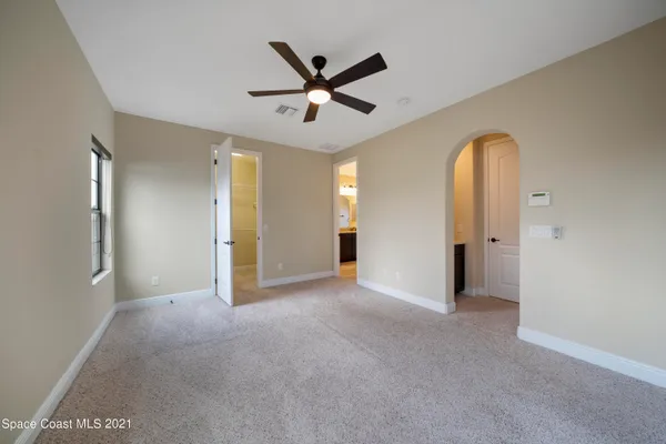 a view of a livingroom with a ceiling fan and window
