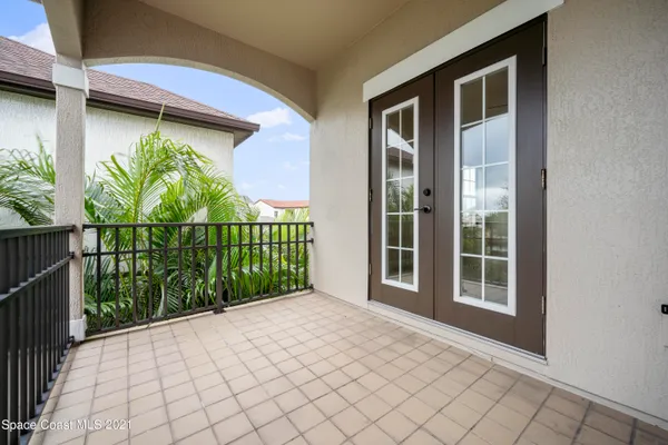 a view of a house with a large window and yard