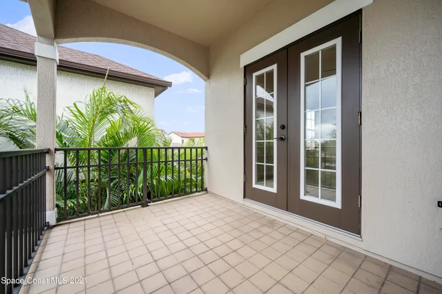 a view of a house with a large window and yard