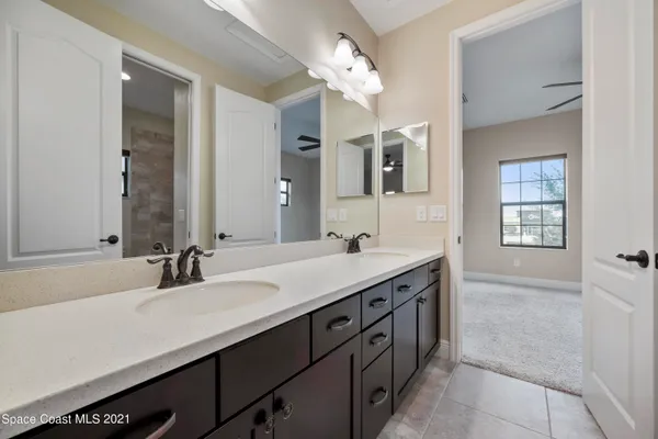 a bathroom with a sink double vanity and a mirror