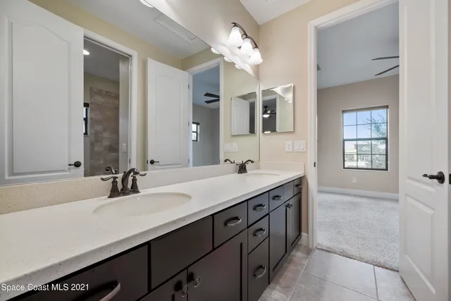 a bathroom with a sink double vanity and a mirror