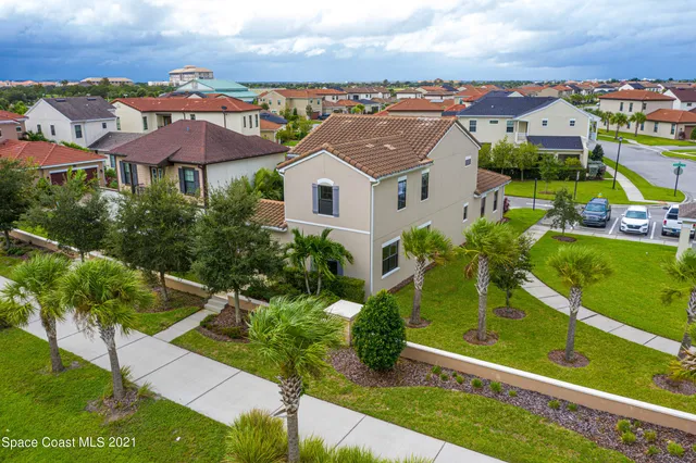 an aerial view of residential houses with outdoor space and street view