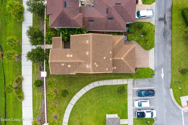 an aerial view of a house with pool patio and lake view
